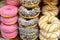 Colorful doughnuts with frosting close-up. Sale of fast food sweets