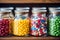 Colorful dragees in glass jars on the shelf of a confectionery store