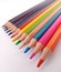 Colorful drawing pencils are neatly lined up on a white background