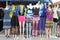 Colorful dresses and pants on mannequins at an outdoor flea market
