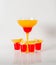 Colorful drink in a margarita glass, red and orange combination, four drinks in a shotglass