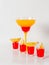 Colorful drink in a margarita glass, red and orange combination, four drinks in a shotglass