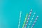 Colorful drinking straws on bright blue background. Birthday, party, menu, eco-friendly concept.