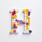 Colorful Drug And Healthcare Concept With Whimsical Pill Letter H