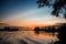 Colorful and dusky skies greet a barge floating down river