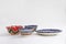 Colorful east ceramic plates and bowls with national pattern in blue and red colors  on white background, Tashkent,