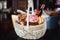 Colorful easter in a basket with, red wine, jamon or jerky and dry smoked sausage on a wooden table