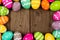 Colorful Easter egg frame against a rustic wood background