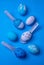 Colorful Easter eggs against a blue background. Lay flat spring theme