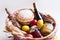 Colorful easter eggs in a basket with cake, red wine, hamon or jerky and dry smoked sausage on white background.