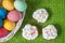 Colorful easter eggs in basket and sweet muffin cupcakes. Easter background. Spring religious holiday easter concept