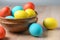 Colorful Easter eggs in brown pottery. Easter eggs are a symbol and a mandatory attribute of Easter