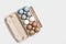 Colorful Easter eggs in carton packing, blue, beige, white neutral colors, festive chicken egg in paper container on