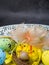 Colorful easter eggs with chickens nest on white plate