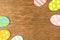 Colorful Easter eggs double side border, old rustic wood background, flat lay design, top view with copy space photo