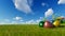 Colorful Easter eggs on green meadow over blue timelapse sky