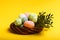 Colorful easter eggs in the rattan nest on the cheerful yellow background.