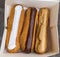 Colorful Eclairs In The Box. Eclairs Laying Inside White Boxes. Eclair Cakes With Scalded Carmel And Coffee Butter Cream