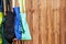 Colorful eco-friendly reusable cloth bags hanging on a pole near a wooden fence