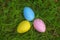 Colorful eggs on fresh springtime grass