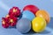 Colorful eggs, symbolizing Easter, on a colorful background and flowers