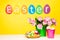 Colorful eggs, word Easter on yellow background