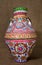 Colorful Egyptian handcrafted artistic ornate pottery jar on sackcloth background