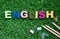 Colorful ENGLISH word cube on green grass yard background ,English language learning concept