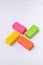 Colorful eraser. Pink, green, yellow and orange
