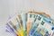 Colorful euro banknotes in fan on wooden table