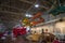 Colorful exotic cars and small airplanes hanging from the ceiling at Lane Motor Museum