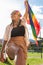 Colorful Expression: Woman Holding a Rainbow Flag on a Sunny Day in the Park