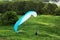 Colorful extreme paraglide on grass