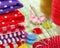 Colorful fabrics, buttons, pin cushion, thimble, spools of thread for sewing