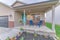 Colorful facade of a house with front yard garden and garage with sectional gray door