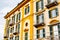 Colorful facade of the house with shutters and small balconies. Varenna, Como, Italy