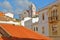 Colorful facades and roofs inside the old town of Silves, with the Cathedral in the background, Silves, Algarve