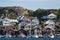 Colorful facades of Swedish summerhouse and sailing boats in harbour