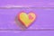 Colorful felt heart on a wooden background with copy space. Valentine background. Happy Valentines symbol. Closeup