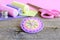 Colorful felt round flower decorated with pink beads. Handmade felt flower, scissors, thread, colorful felt sheets, thimble