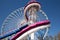 Colorful Ferris wheel against a clear blue sky big wheel carousel with white pink giant slide