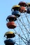 Colorful ferris wheel slowly moving against blue sky in the amusement park