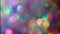 Colorful festive texture. Pastel neon colors defocused lights bokeh. Sparkling highlights and rainbow colors. Abstract