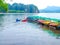 Colorful fiberglass kayaks on outdoor storage in the sea