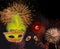 Colorful fireworks at black night sky and mask with feathers
