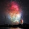 Colorful fireworks in harbor over sailing boats night scene