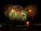 Colorful fireworks with multiple bursts against dark sky