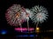 Colorful fireworks with multiple bursts against dark sky