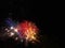 Colorful fireworks of various colors light up the night sky