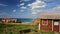 Colorful Fisherman`s huts on Alentejo West Coast with dramatic cliffs in the background, Porto das Barcas, Zambujeira do Mar, Alen